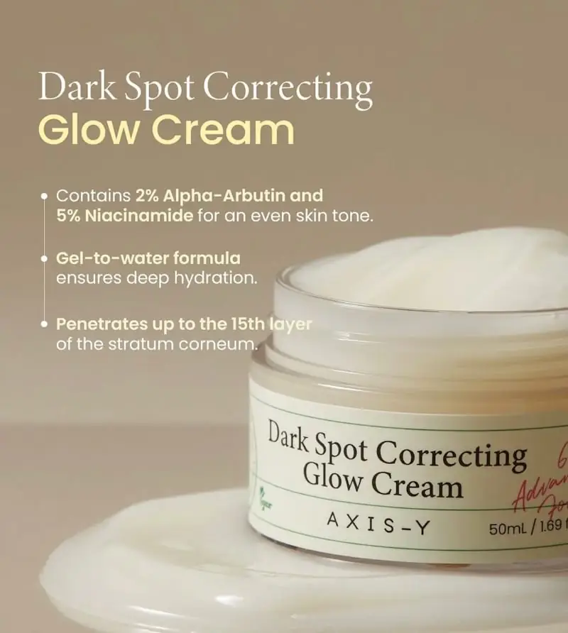 Open Axis-y Glow Cream jar revealing white cream; finger applying product from it. - thumbnail