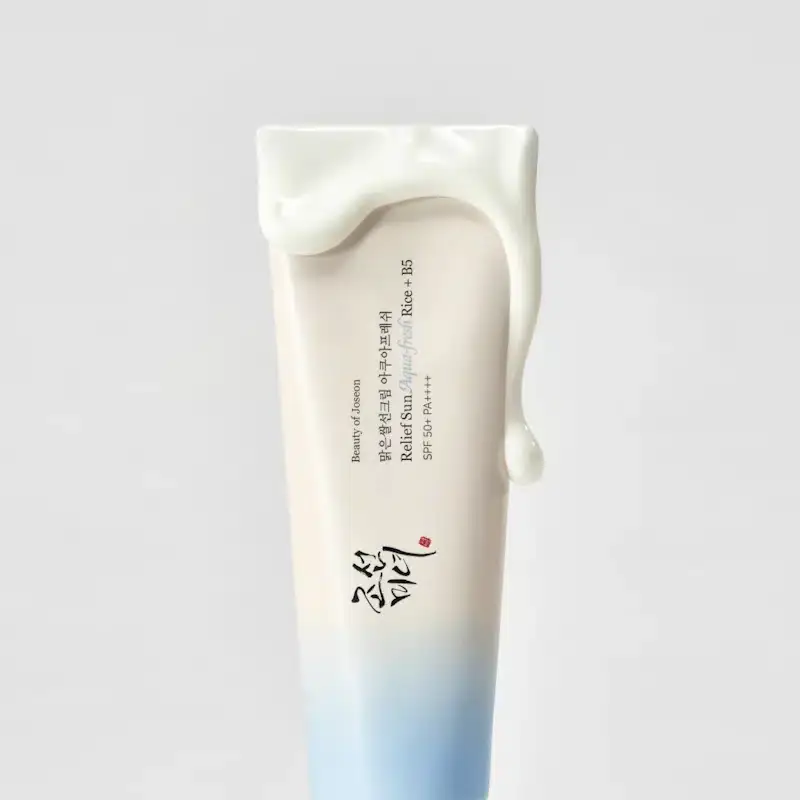 Creamy white texture of Beauty of Joseon Relief Sun Aqua-Fresh sunscreen, with tube blurred in background. - thumbnail