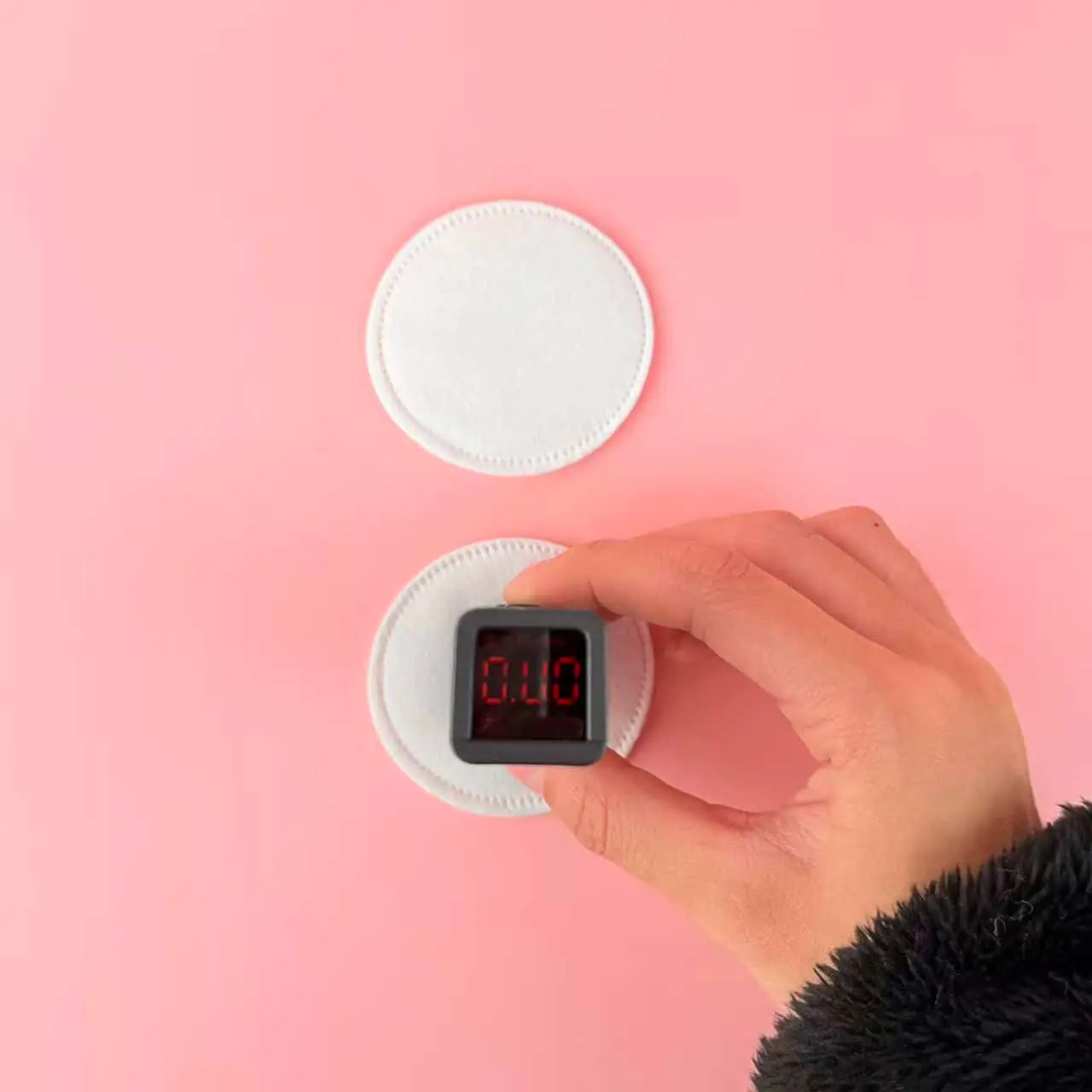 Caplino lint-free cotton pad applying clear liquid gently to clean skin. - thumbnail