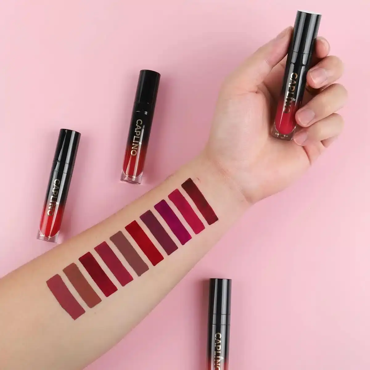 Open Caplino Dazzling 09 liquid matte lipstick with applicator wand dipped in the vibrant shade. - thumbnail