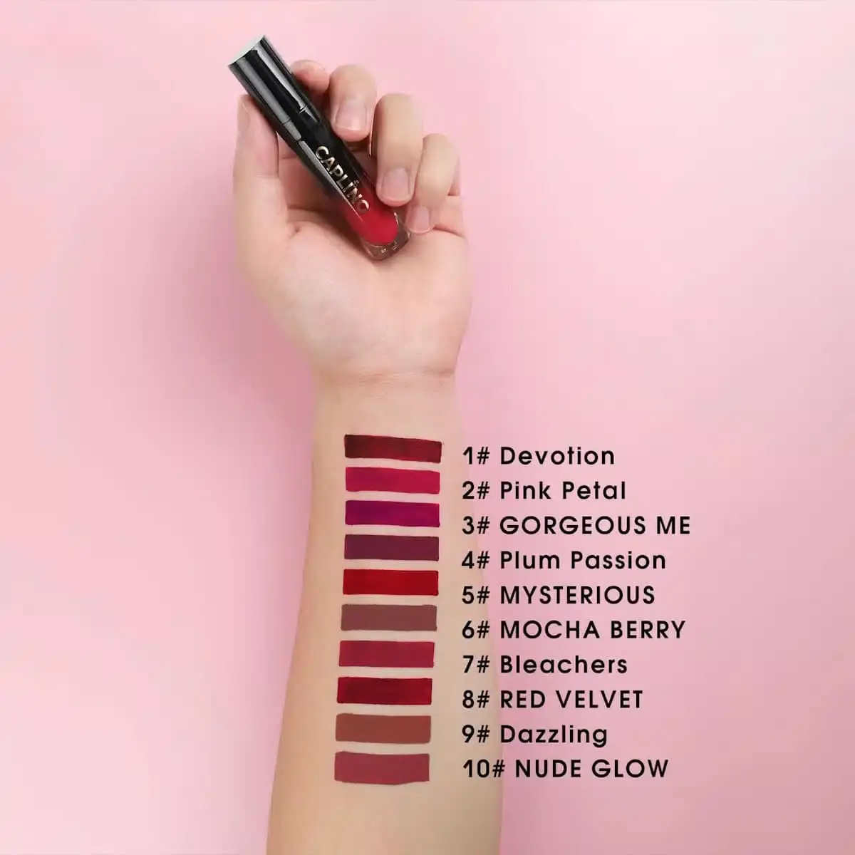 Hand holding Caplino Dazzling 09 liquid matte lipstick with a vibrant swatch on the skin. - thumbnail