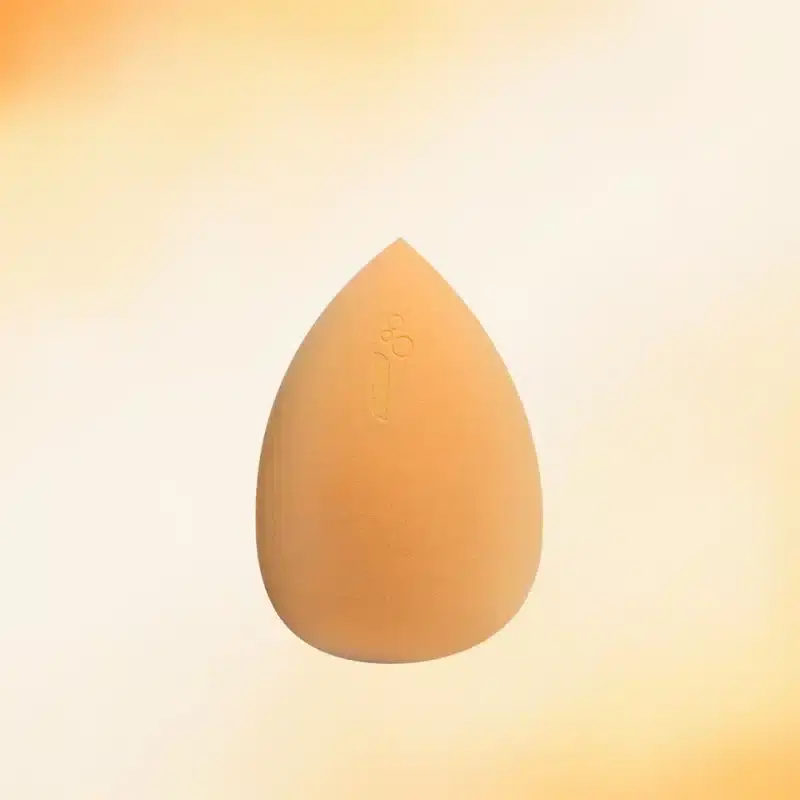 Caplino yellow makeup sponge lying on its side, showcasing its soft, bouncy texture for smooth application. - thumbnail