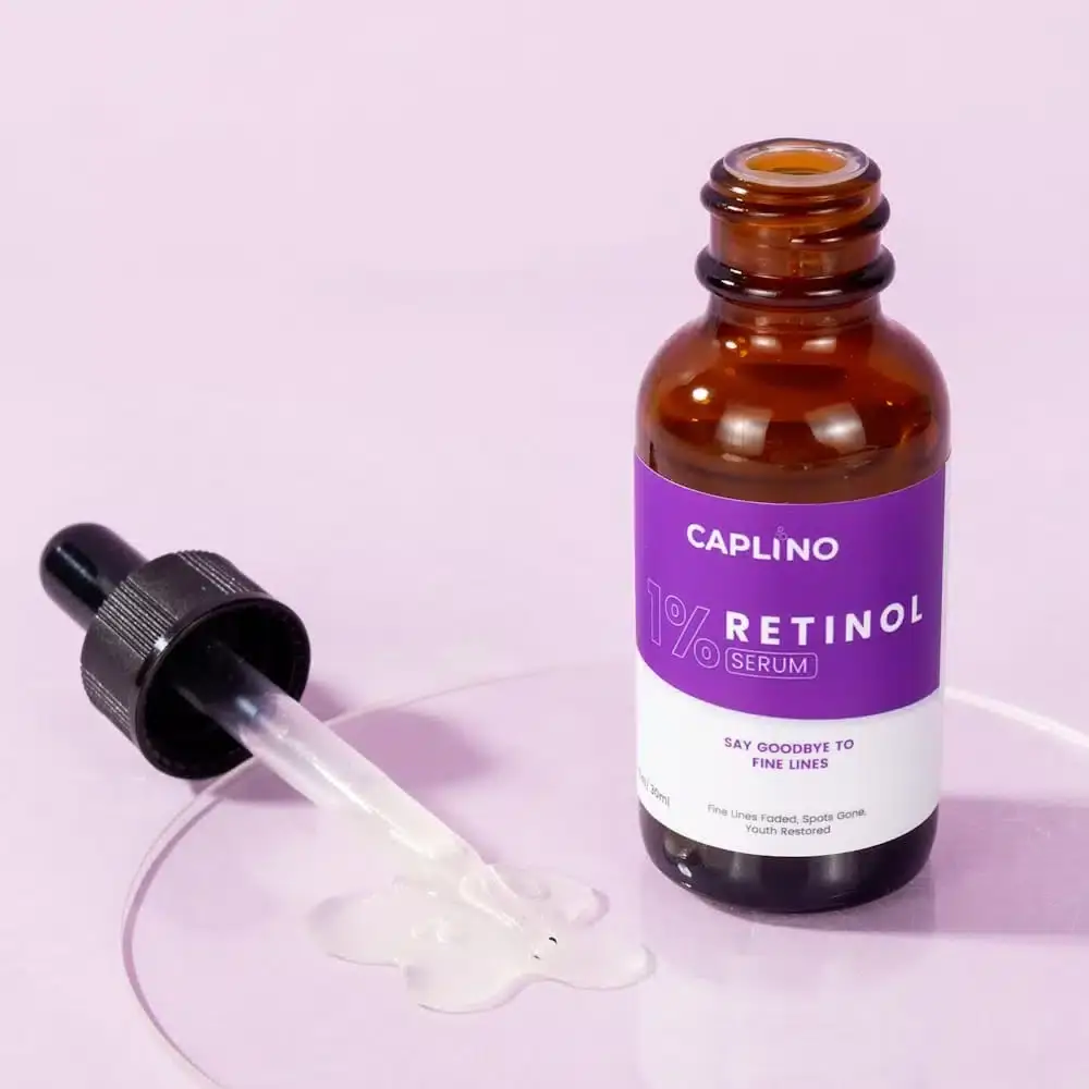 Close-up of Caplino 1% Retinol Serum bottle with dropper pulled out, showing clear liquid. - thumbnail