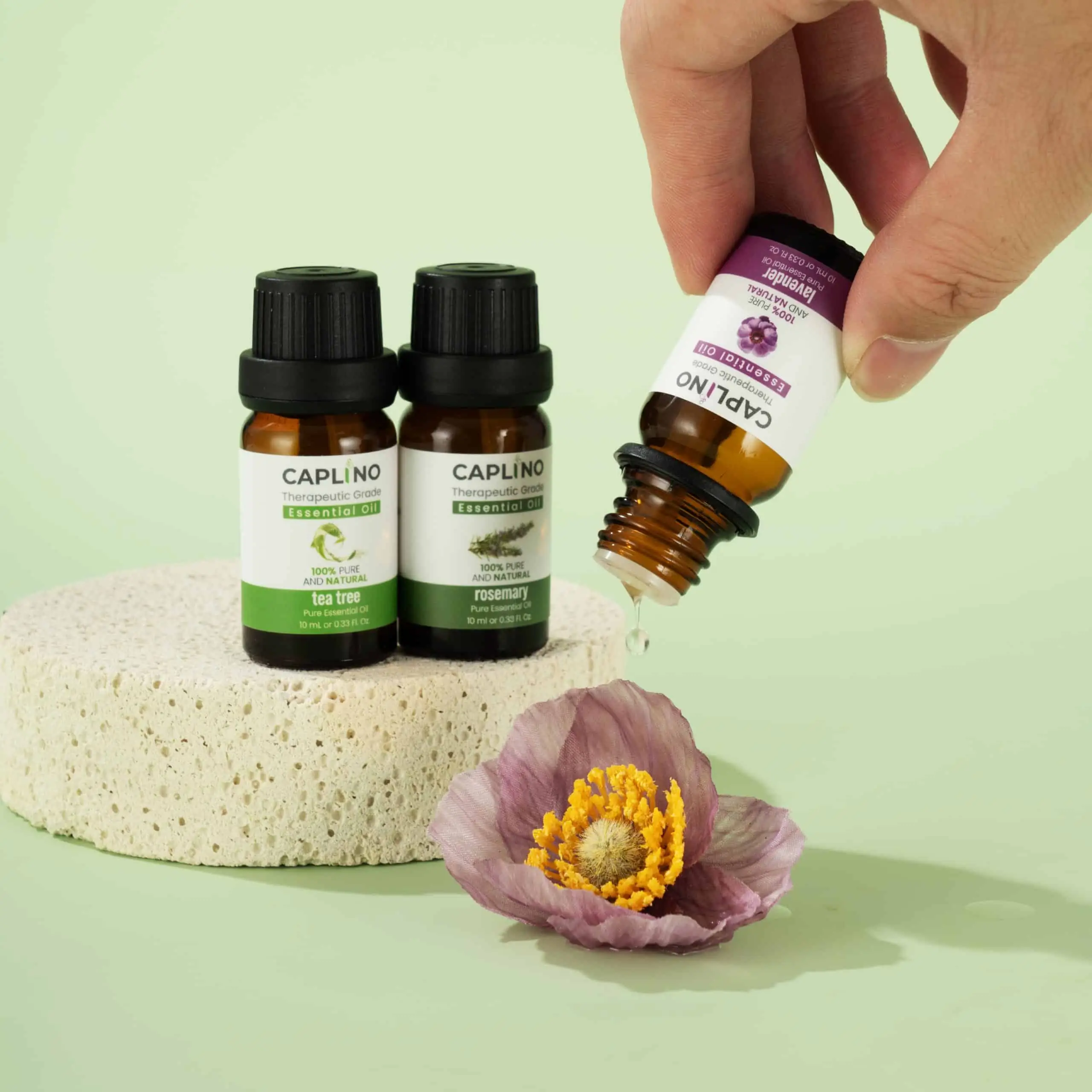 Caplino Rosemary Essential Oil drops visibly dispensed from the dropper, illustrating texture and usage. - thumbnail
