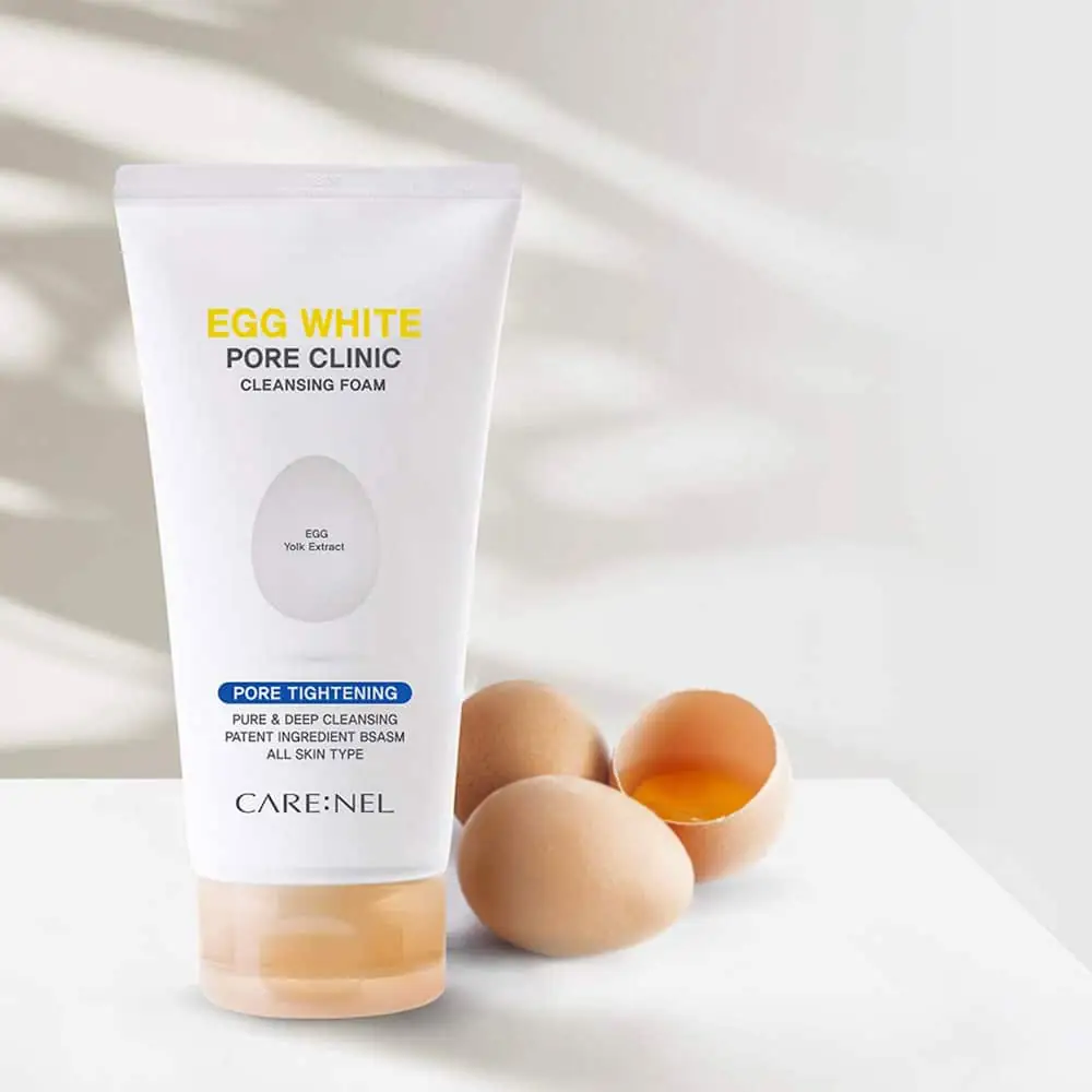 Creamy white Carenel Egg White cleansing foam texture, a dollop displayed on a fingertip. - thumbnail
