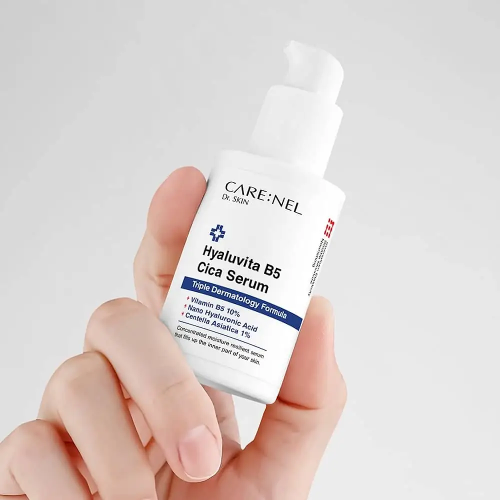 Carenel Hyaluvita B5 Cica Serum bottle held gently in a hand, showing its compact size. - thumbnail