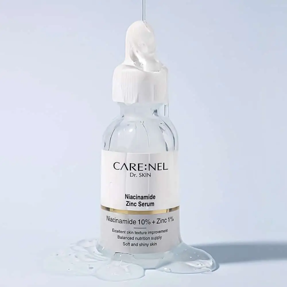 Carenel Niacinamide 10% Zinc 1% serum swatched clearly on skin with bottle. - thumbnail