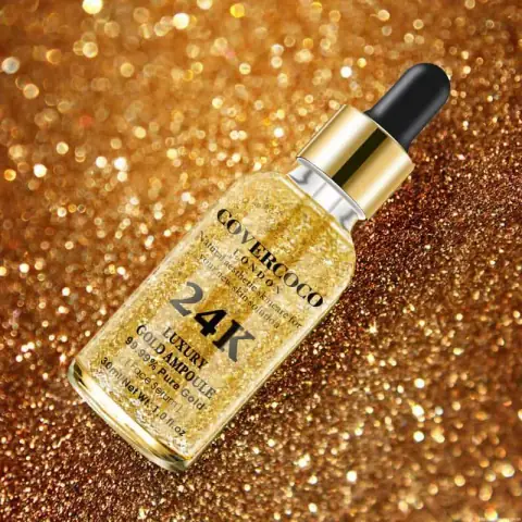 Clear RuSu Covercoco 24k Gold Luxury Ampoule bottle with visible shimmering golden serum and dropper.