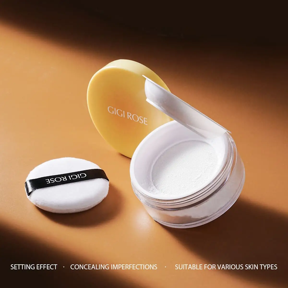 Close-up of GiGi Rose Translucent Loose Powder, white puff with powder, sifter visible. - thumbnail