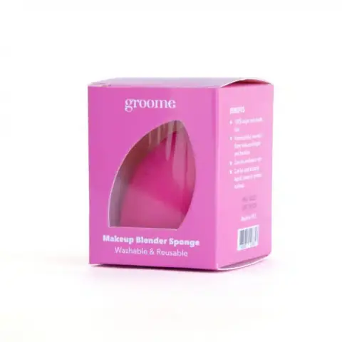 Groome pink teardrop makeup blender sponge standing upright on a clean white background, ready for use.