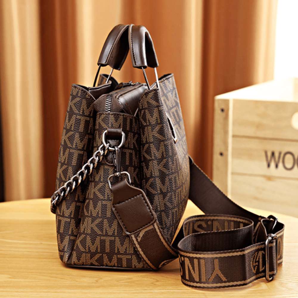 RuSu Luxury Portable Women Bag in deep coffee brown, styled with daily accessories on a table. - thumbnail