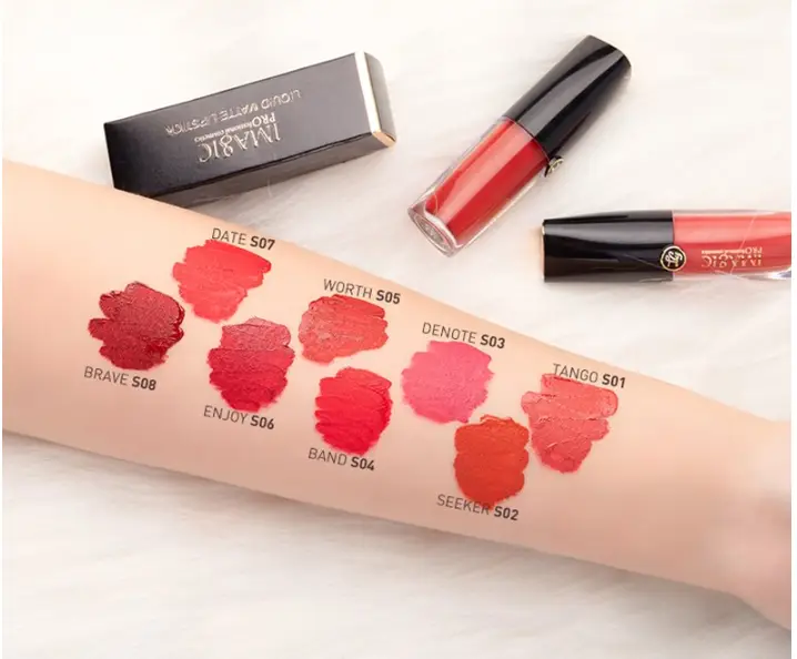 Close-up of Imagic liquid matte lipstick tube with a nude-brown arm swatch. - thumbnail