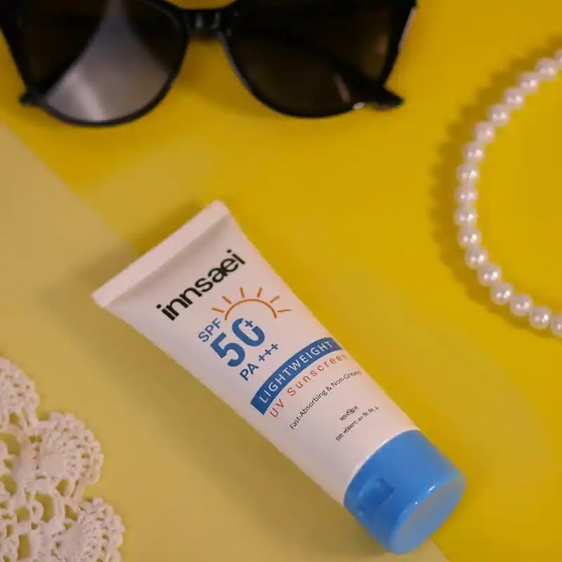 Innsaei Lightweight UV Sunscreen tube with white creamy texture squeezed out, angled view. - thumbnail