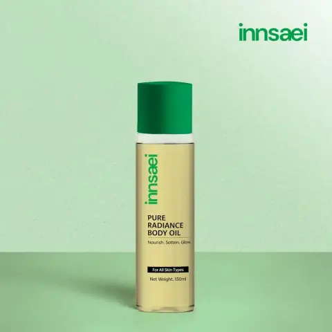 Innsaei Pure Radiance Body Oil in a clear 150ml pump bottle, showcasing golden liquid.