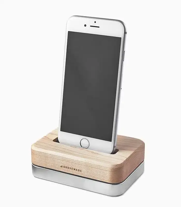 Side view of the RuSu black iPhone dock securely holding a white smartphone for charging. - thumbnail