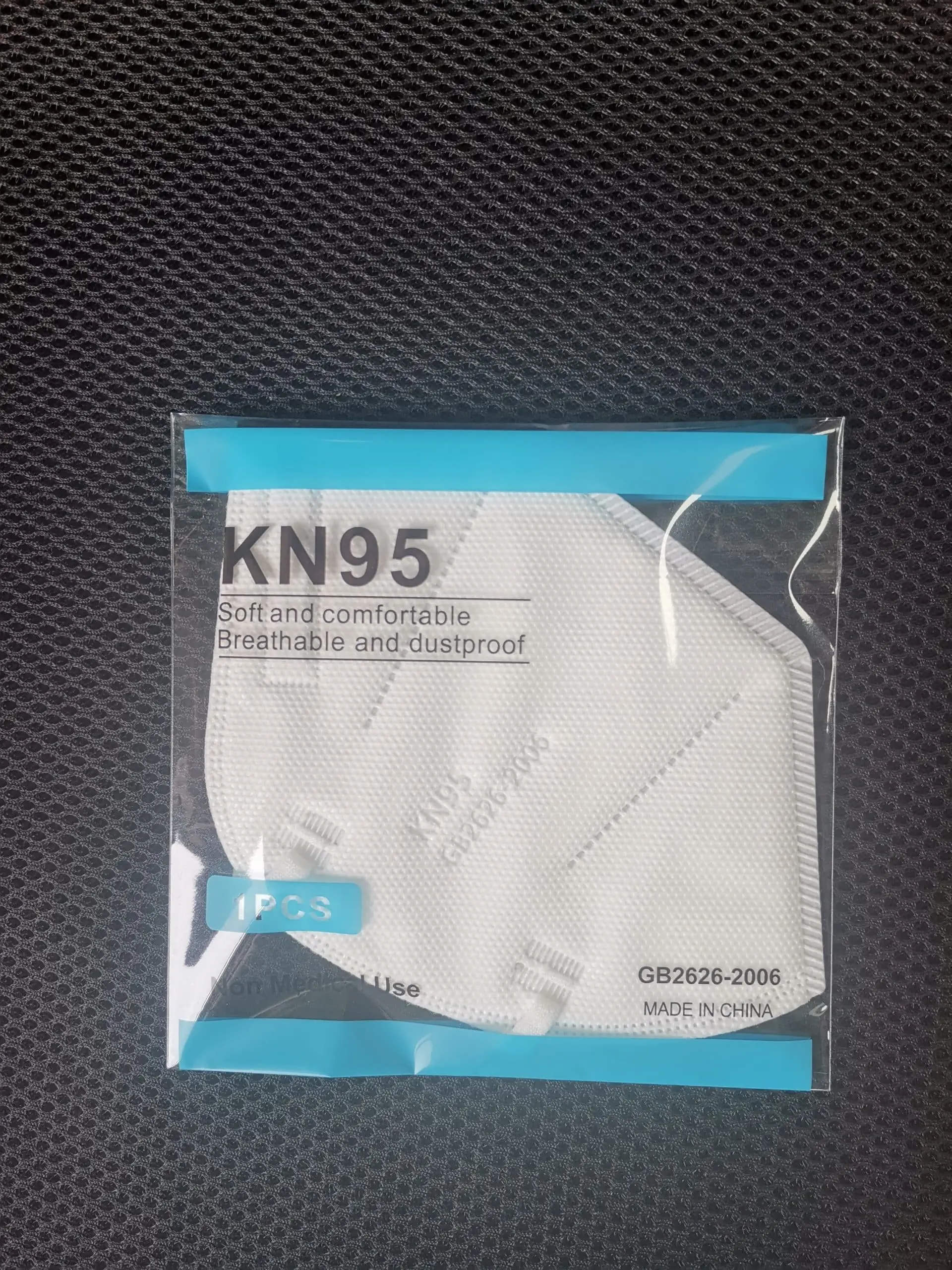 Close-up view of the multi-layered texture on the white RuSu KN95 protective mask material. - thumbnail