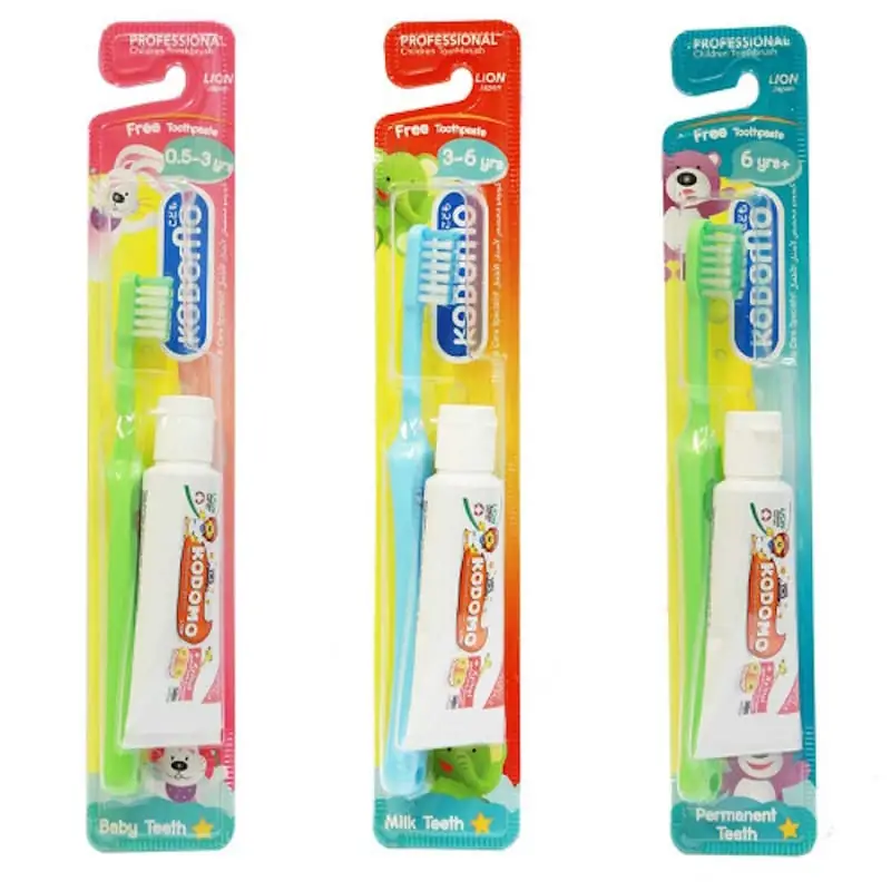 Close-up of the Kodomo baby toothbrush, showing soft blue bristles and ergonomic yellow handle design. - thumbnail