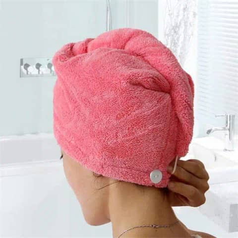 Aichun Beauty pink hair dry cap laid flat, showcasing the button and elastic loop closure.