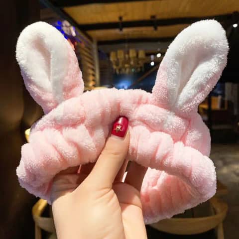 Pair of plush pink Laikou rabbit ear hair bands featuring cute fluffy tails.
