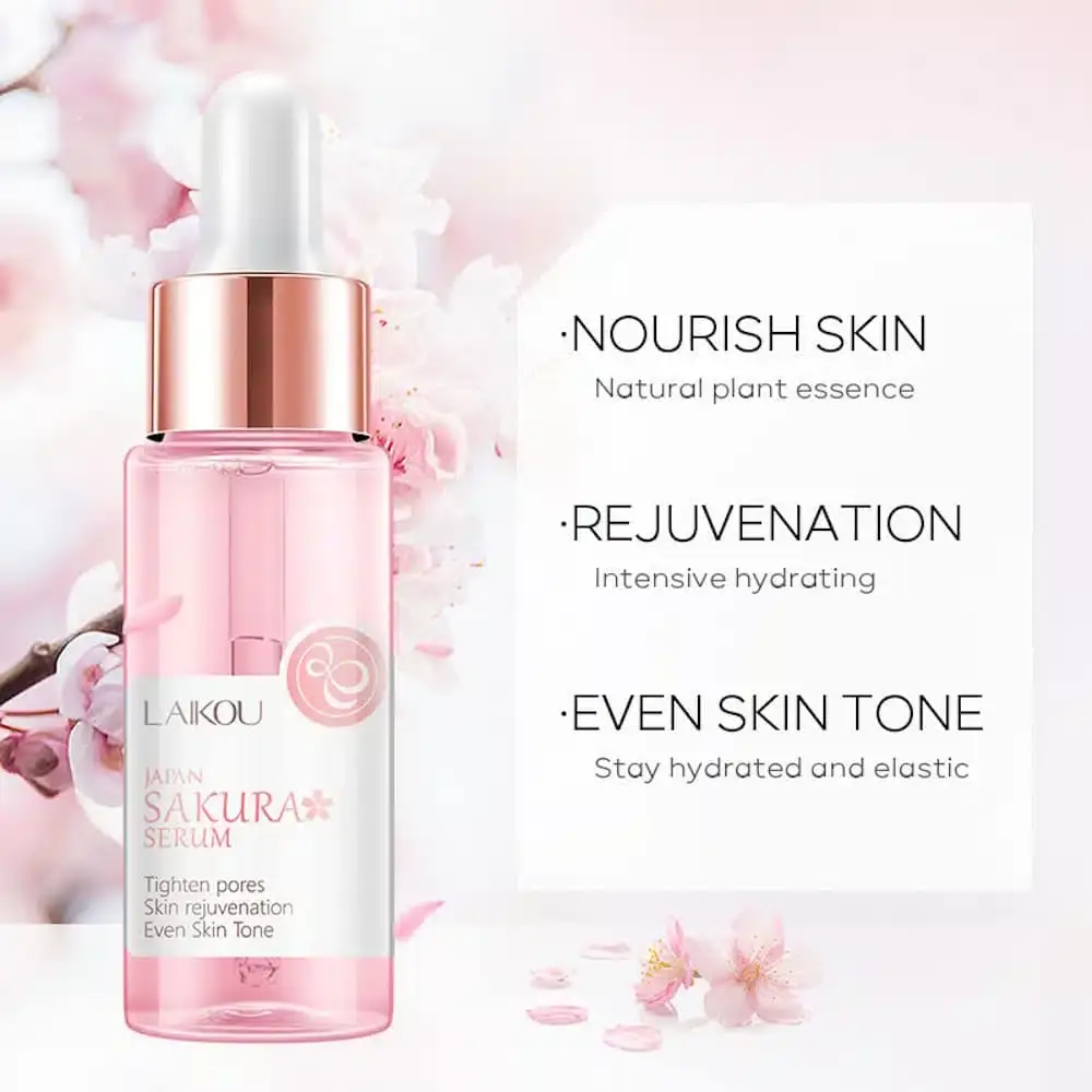 Hand holds Laikou Japan Sakura Serum bottle, a clear drop falling from the dropper. - thumbnail