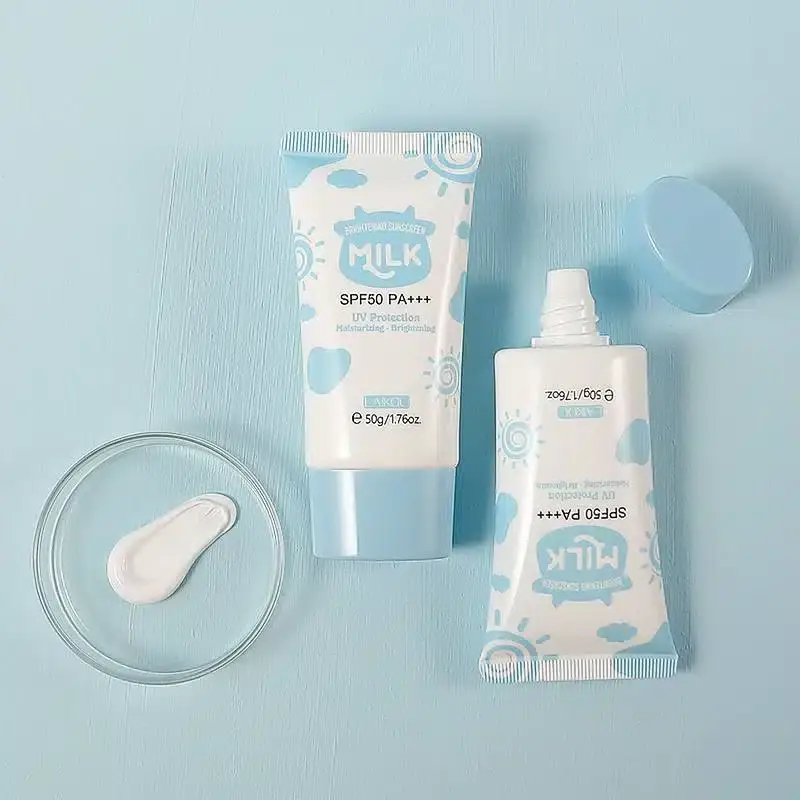 White Laikou Milk Brightening Sunscreen cream texture squeezed out, tube in background. - thumbnail