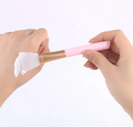 Laikou sky blue silicone facia mask applicator brush lying horizontally, full length view. - thumbnail