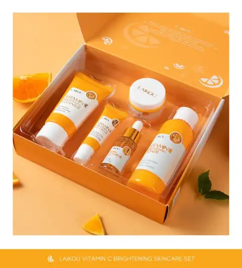 Full Laikou Vitamin C brightening skincare set with five orange-bottled products and fresh citrus.
