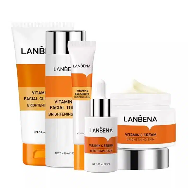 Lanbena Vitamin C skincare combo: five orange and white bottles and tubes, complete set arranged. - thumbnail