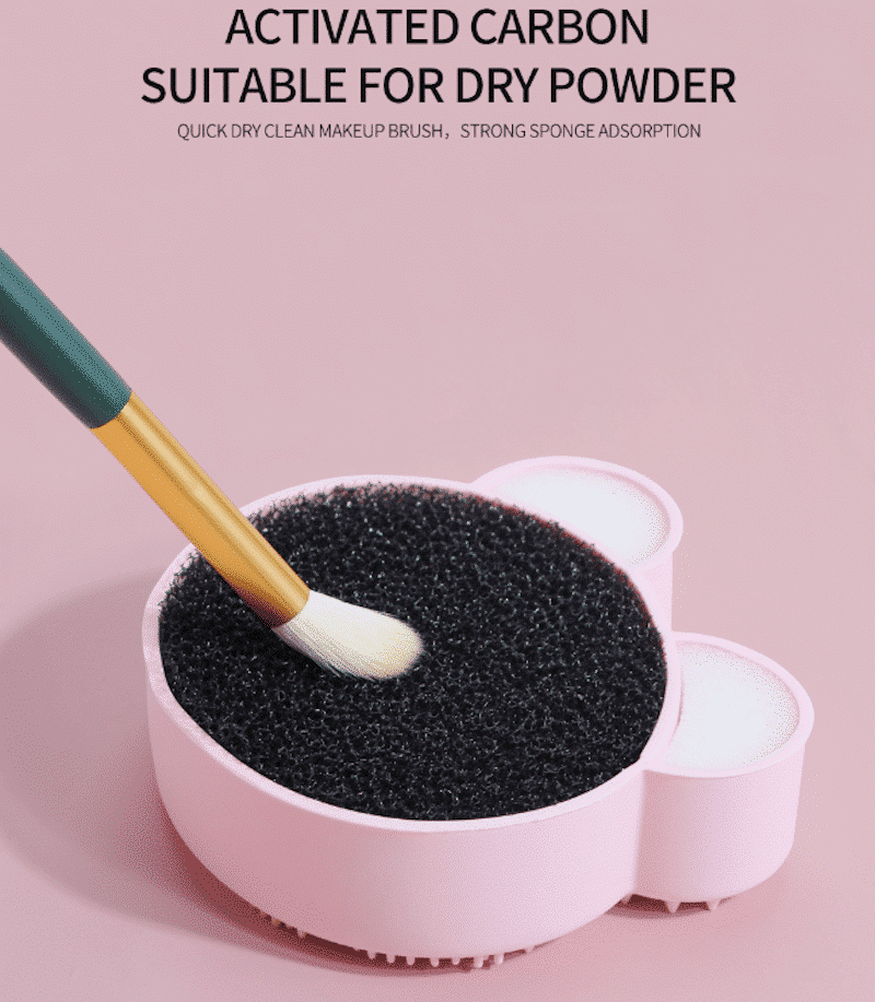 Hand demonstrating Maange bear silicone makeup brush cleaner pad texture with a dark brush. - thumbnail