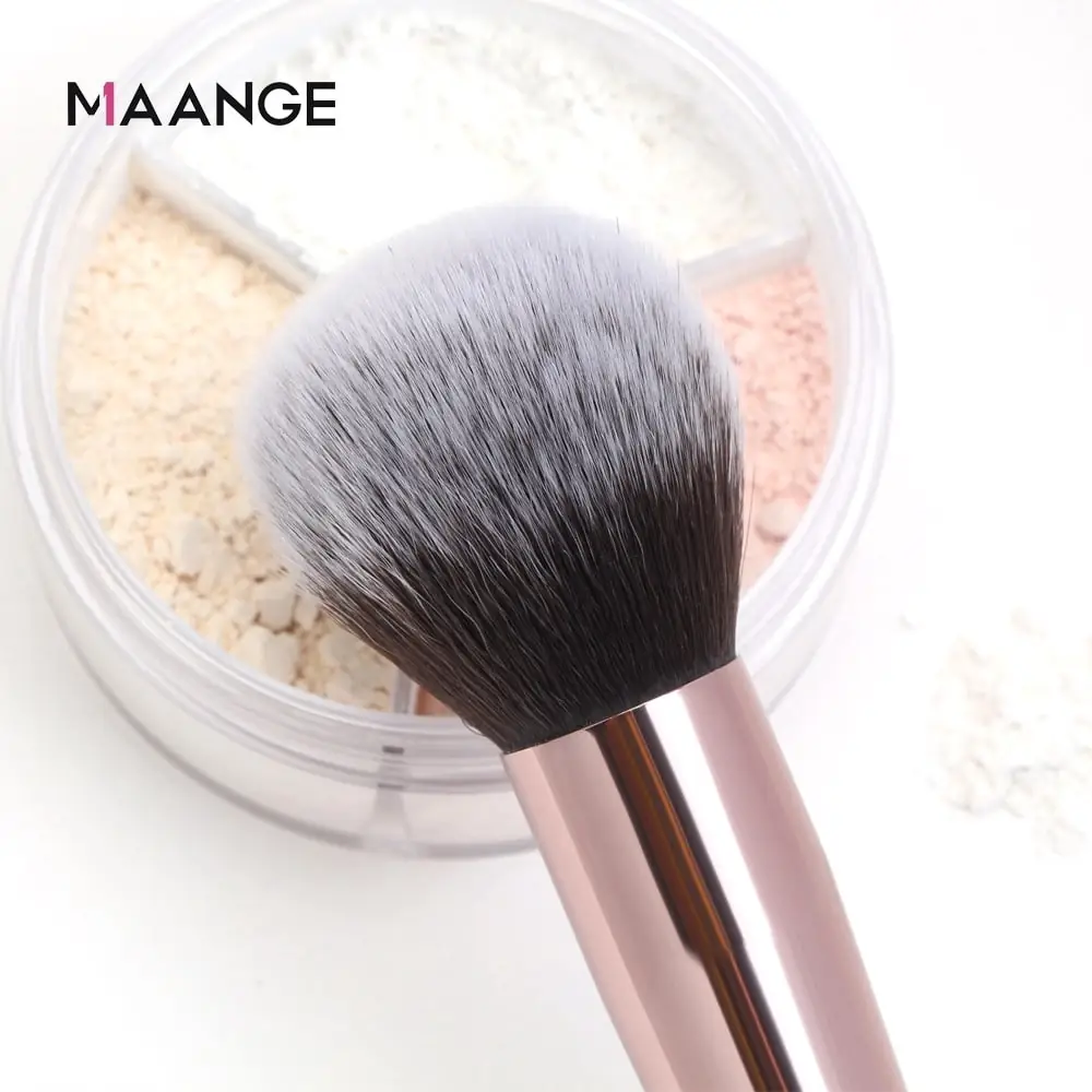 Maange powder brush held in hand, demonstrating its size and how to apply makeup. - thumbnail