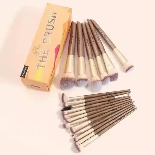 Maange gold handle makeup brushes standing in a clear holder, showcasing diverse brush heads. - thumbnail