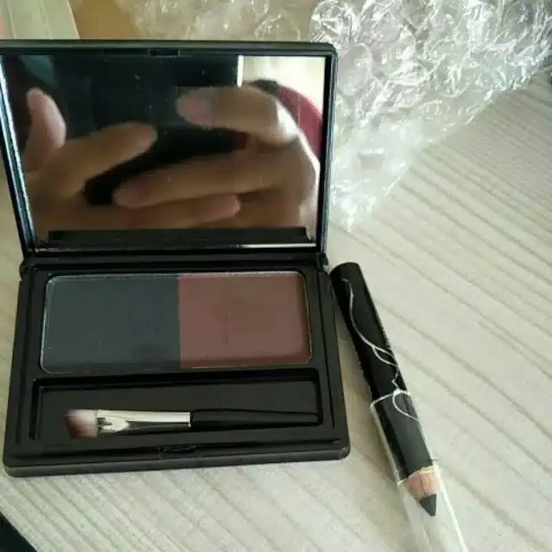Sleek black Menow Attractive Eyebrow Powder compact shown closed from a professional angled perspective. - thumbnail