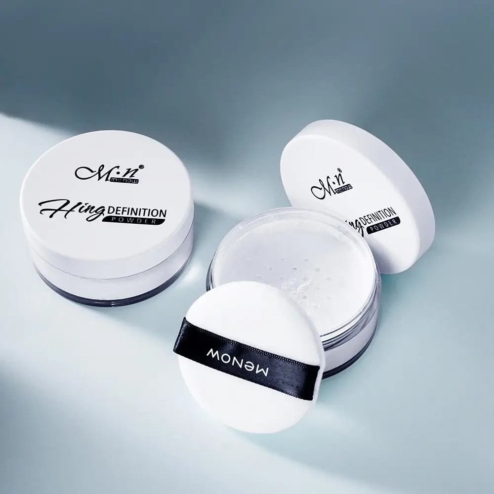 Close-up of Menow translucent loose powder's fine white texture with a fluffy application puff. - thumbnail