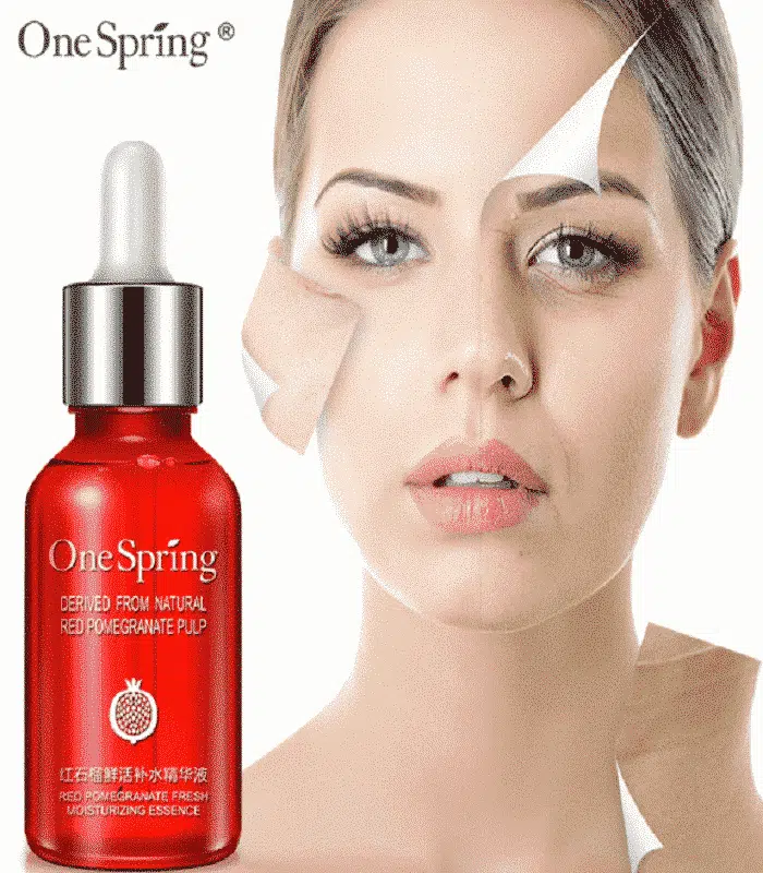 Hand dispensing a nourishing drop of One Spring Red Pomegranate essence serum for application. - thumbnail