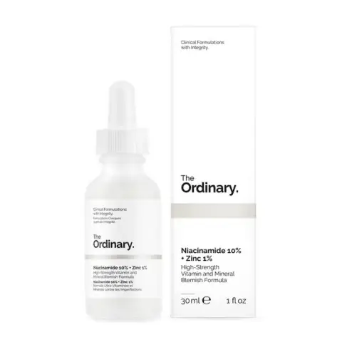 Front view of The Ordinary Niacinamide 10%+Zinc1% serum's white bottle and visible dropper.