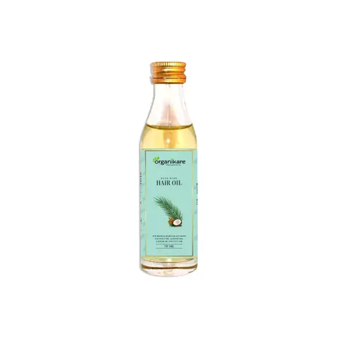 Organikare Handmade Hair Oil in a clear glass dropper bottle with rich amber liquid.