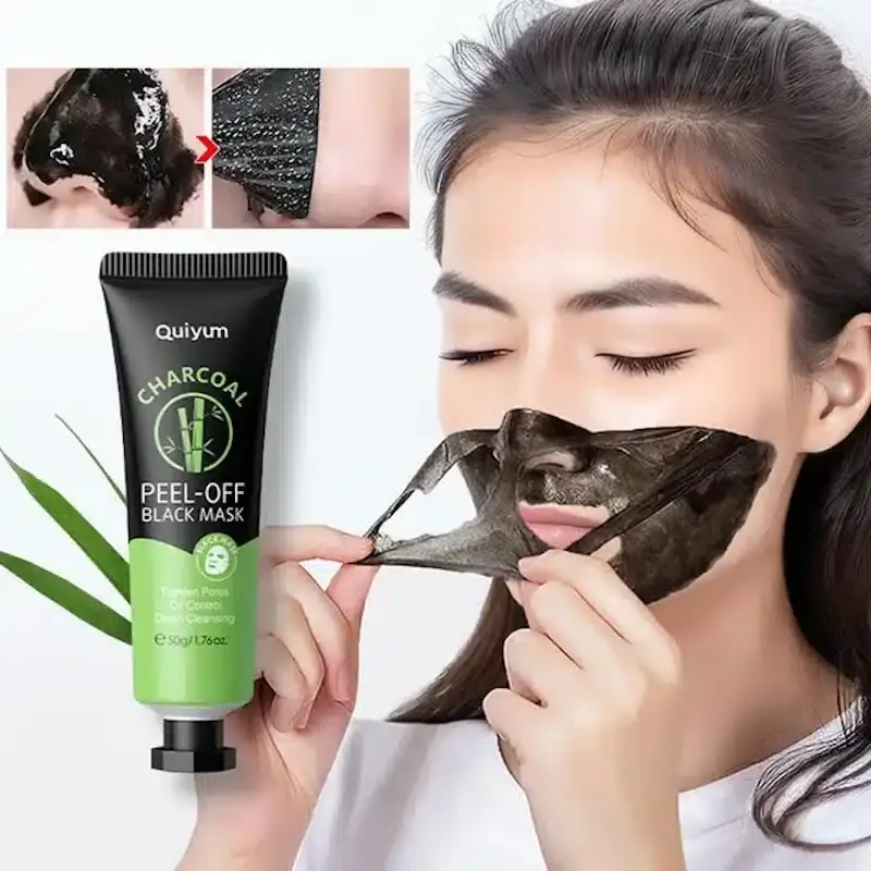Quiyum Charcoal Blackhead Remover Peel-off Mask tube lying down with dark glossy product swatch. - thumbnail