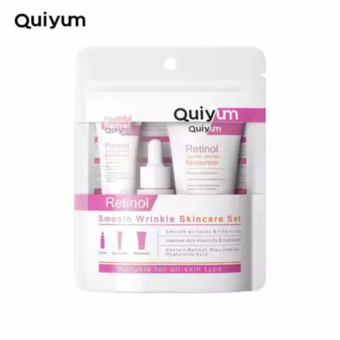 Quiyum Retinol 3-piece skincare set featuring gold tube, pump bottle, and jar on a white background.