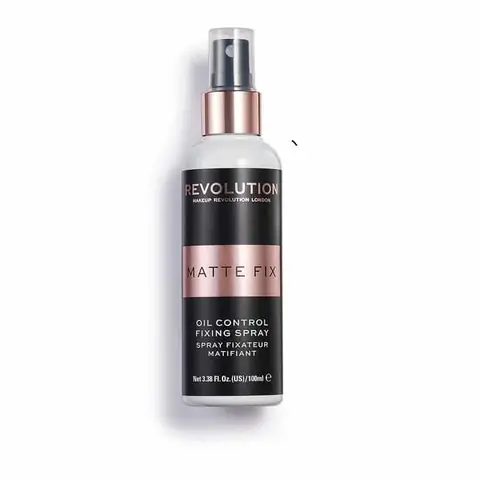 Revolution Oil Control Fixing Spray 100ml matte black bottle, standing upright on a clean background.