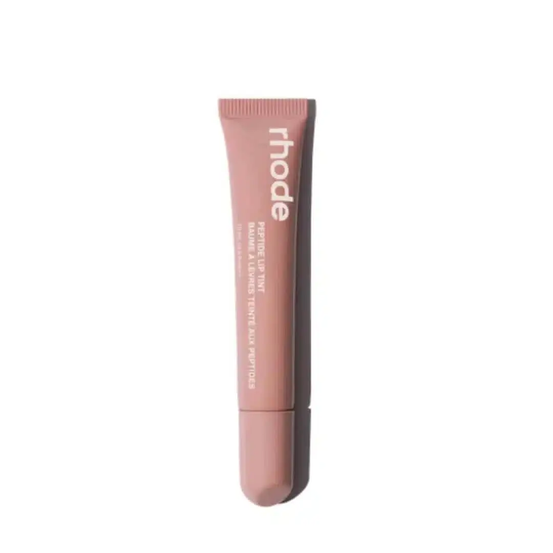 Rhode Peptide Lip Tint in Toast, sleek white tube standing upright with peachy-nude cap. - thumbnail