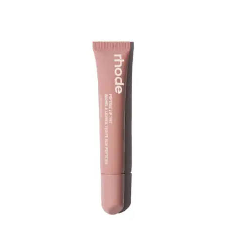 Rhode Peptide Lip Tint in Toast, sleek white tube standing upright with peachy-nude cap.