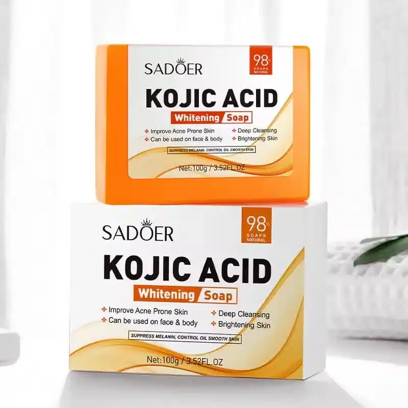 Unwrapped Sadoer Kojic Acid Whitening Soap bar, bright orange, with "SADOER" embossed on it. - thumbnail
