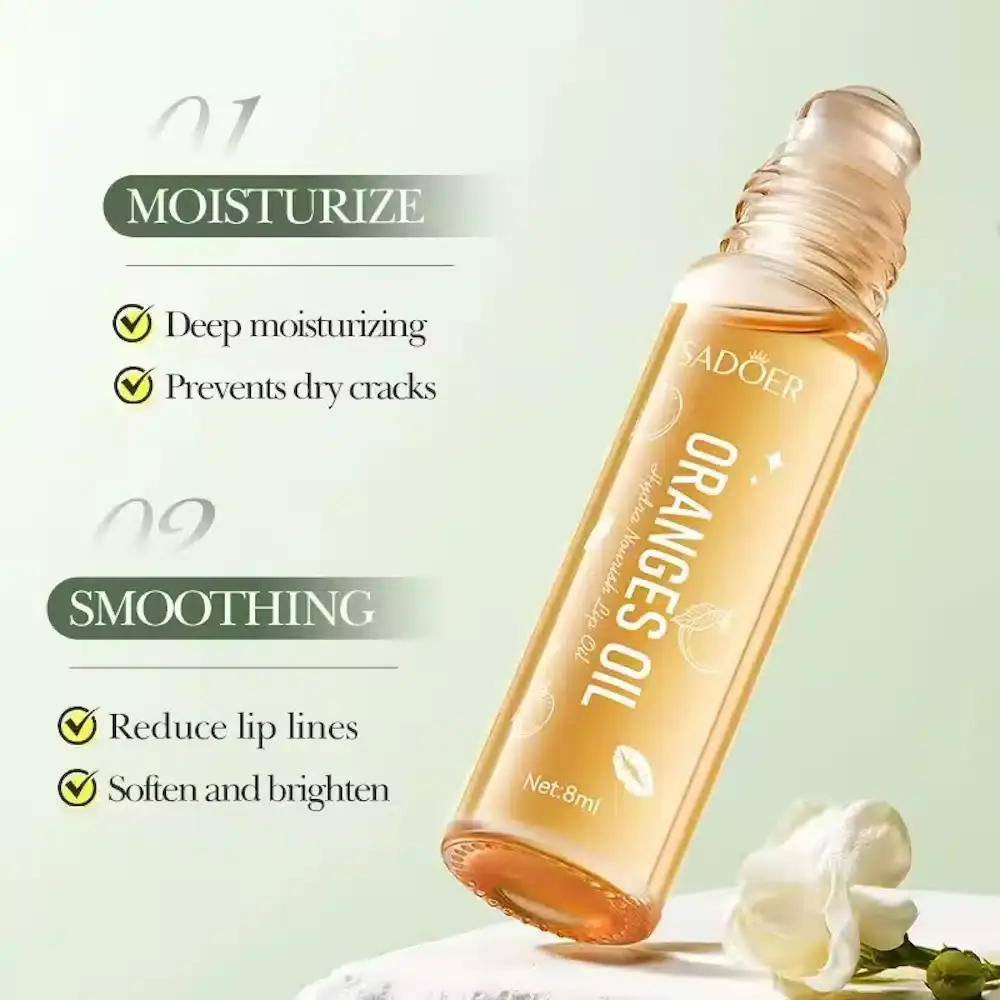 Sadoer Oranges Lip Oil clear tube with its applicator wand extended, showing glossy oil. - thumbnail