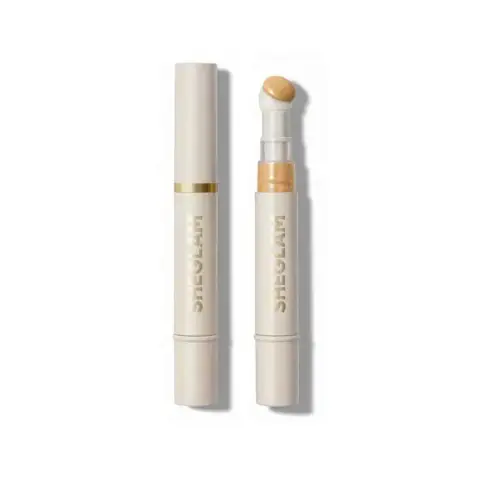 Sheglam Concealer in Shell shade, a sleek tube standing upright, clearly displaying brand and shade.