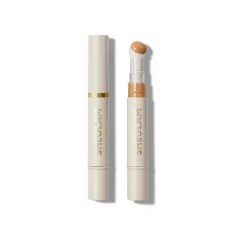 Sheglam Warm Vanilla liquid concealer in a clear tube with a gold cap and applicator.