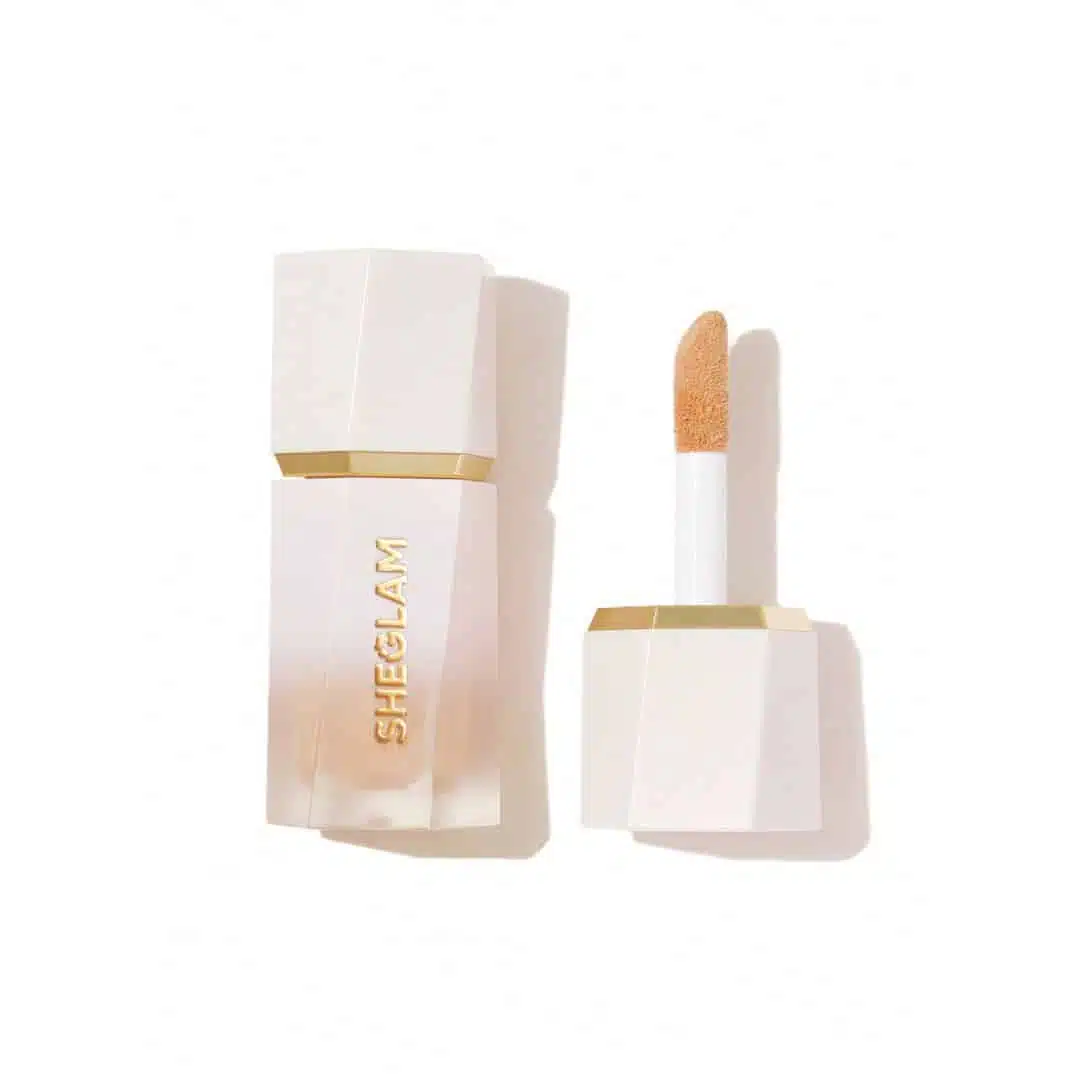 Sheglam Liquid Highlighter 'Tea Cake' in clear glass bottle with white dropper, front view. - thumbnail