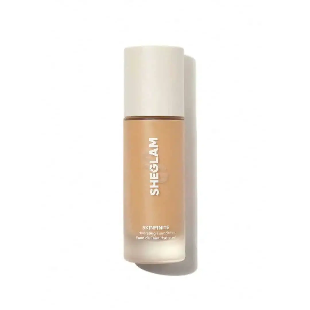 Sheglam Skinfinite Hydrating Foundation in Honey shade, clear glass bottle with elegant gold cap, front view. - thumbnail