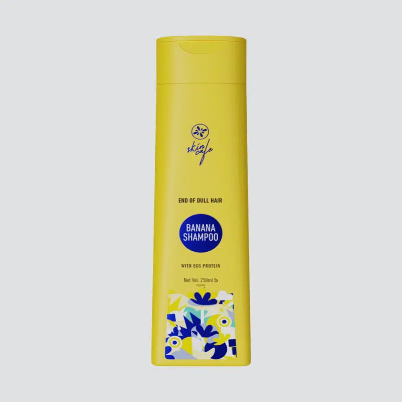 Skin Cafe Banana Shampoo 250ml in a vibrant yellow pump bottle with egg protein.