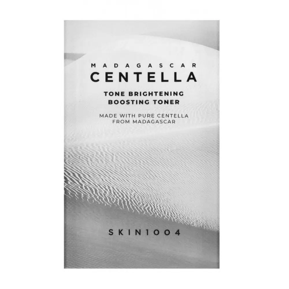 Skin1004 Madagascar Centella Tone Brightening Boosting Toner 1.5ml sachet, white and green pouch, frontal view.
