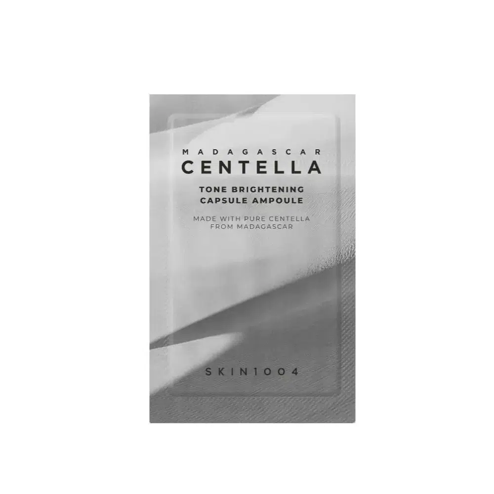 Skin1004 Madagascar Centella Tone Brightening 1.5ml ampoule, clear glass vial showing white capsules.